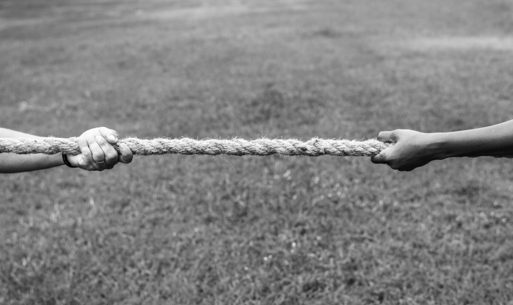 closeup of hand pulling the rope in tug of war game